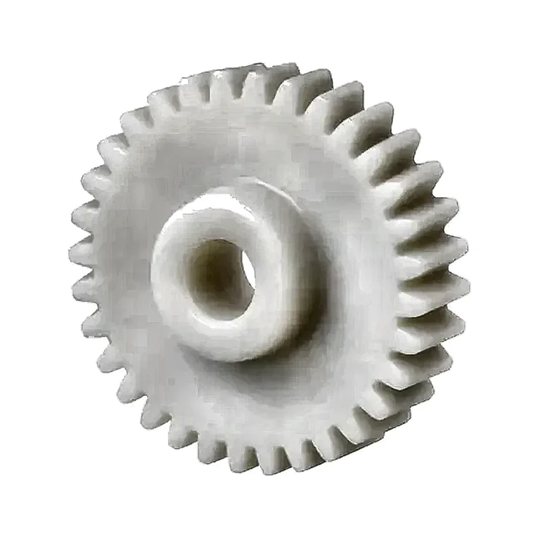 Representative photograph of a white engineering-plastic spur gear on a clean background; exact POM/acetal grade, tooth geometry and shaft interface follow the released drawing.